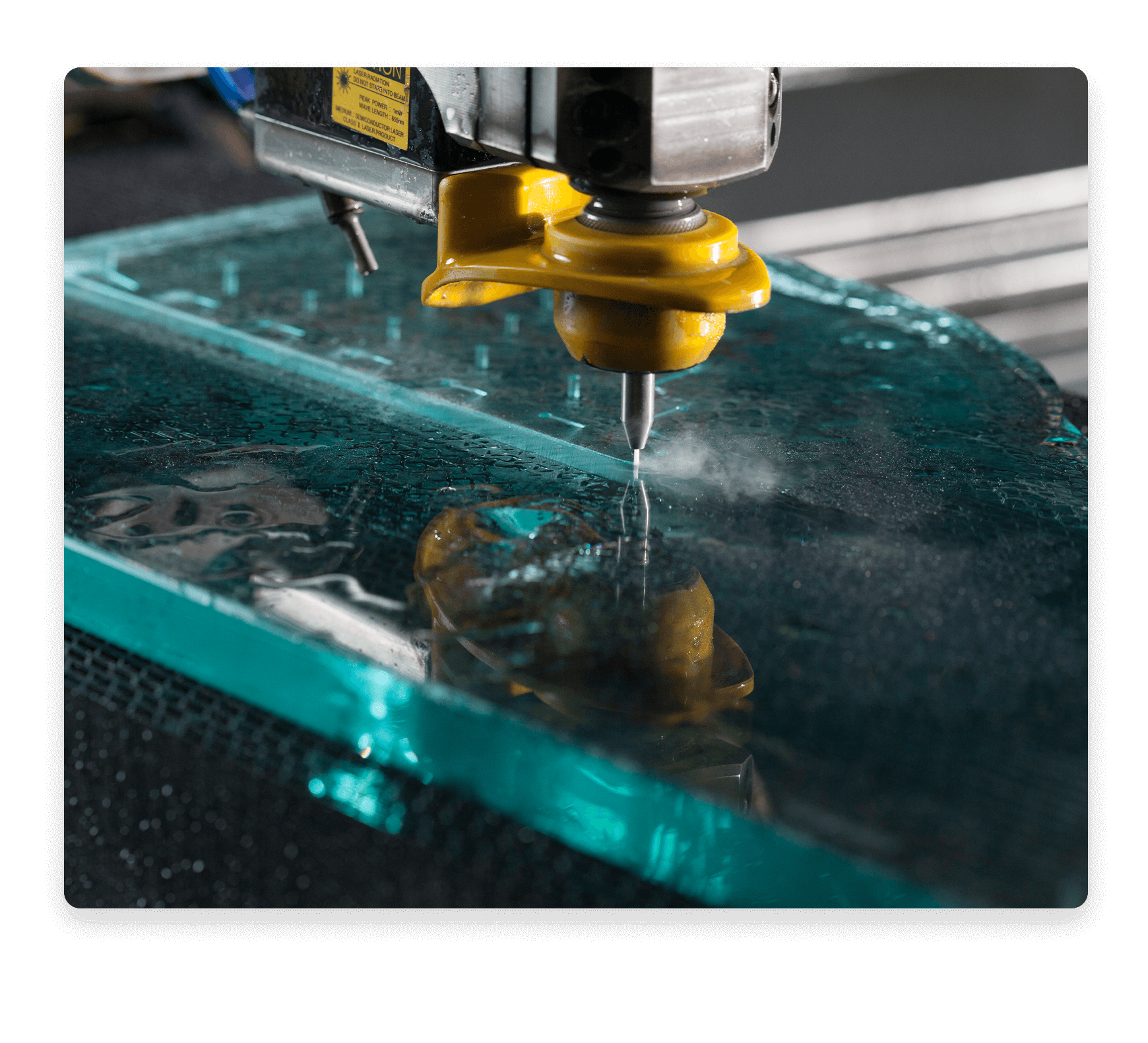 Waterjet cutting head cutting glass.